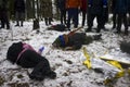 Ambulance drills in the winter forest. Several allegedly drunk people lie with knives and axes in their backs and resist Royalty Free Stock Photo