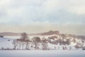 Ambulance driving on snowy road. Snowfall on the fields. Rural landscape with winter weather Royalty Free Stock Photo