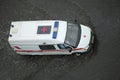 Ambulance car going through the flooded road Royalty Free Stock Photo
