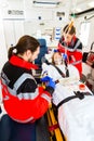 Ambulance helping injured woman with infusion