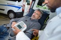 Ambulance man monitoring heartrate patient