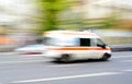 Ambulance in motion driving down the road Royalty Free Stock Photo