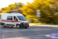 Ambulance in motion driving down the road. Intentional motion blur Royalty Free Stock Photo