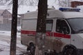 Ambulance near the house on a snowy day
