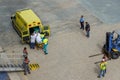 Ambulance personnel and cruise ship crew on a dock in Aruba taking a passenger off the ship