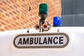 Ambulance sign with blue and green flashing lights. Royalty Free Stock Photo