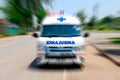 Emergency ambulance travels through city street, Zoom effect applied for dramatic effect, Ambulance first aid abstract motion blur Royalty Free Stock Photo