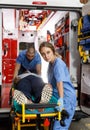 Ambulance team laying patient on stretcher Royalty Free Stock Photo