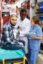 ambulance team providing medical care to ill male patient in ambulance car Royalty Free Stock Photo