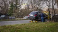 An ambulance truck picks up a damaged car in the city. Royalty Free Stock Photo