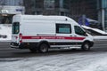 ambulance van in motion driving down winter road. Special car of paramedic emergency riding through street on high speed Royalty Free Stock Photo