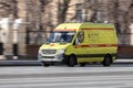ambulance van in motion driving down winter road. Special car of paramedic emergency riding through street on high speed