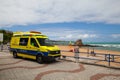 An ambulance van, parked in the beach area.