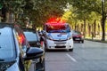 Ambulance van parked on the roadside with the emergency lights flashing Royalty Free Stock Photo