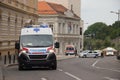 Ambulance vehicle on the street, with Police in background, securing public event