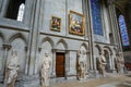 The ambulatory of the interior of the Rouen Cathedral in Rouen France with stained glass windows, statues and renaissance painting