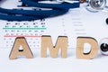 AMD Abbreviation or acronym of age-related macular degeneration - eye problem in older persons. Word AMD is on foreground near eye Royalty Free Stock Photo