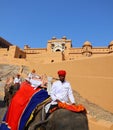 Amer Fort or Amber Fort. Decorated elephants and elephant riders waiting for tourists