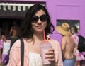 Amerasian teenager in the sun with a milkshake