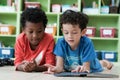 American and African boys are reading together with happiness in