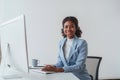 American African friendly operator woman agent with headsets working in a call center. Help desk client online Royalty Free Stock Photo