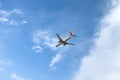 American Airlines plane is flying in blue sky on sunny day. Travel, vacation, air transportation.