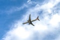 American Airlines plane is flying in blue sky on sunny day. Travel, vacation, air transportation.