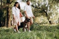 American Akita dog for a walk with a guy and a girl
