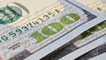 American banknotes of one hundred dollars. Fragment of bills close-up. New sample money. Focus on the number 100. Economy, savings Royalty Free Stock Photo