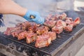 American barbecue behind the city for a large company on a weekend. Close-up cooking of large juicy pieces of raw, fat Royalty Free Stock Photo