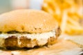 american beef hamburger with cheese and french fries at beautiful fast food and cafe bistro.delicious low price hamburger in Royalty Free Stock Photo