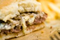 american beef hamburger with cheese and french fries at beautiful fast food and cafe bistro.delicious low price hamburger in Royalty Free Stock Photo