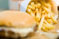 american beef hamburger with cheese and french fries at beautiful fast food and cafe bistro.delicious low price hamburger in Royalty Free Stock Photo