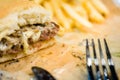 american beef hamburger with cheese and french fries at beautiful fast food and cafe bistro.delicious low price hamburger in Royalty Free Stock Photo