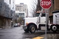 American big rig semi truck turn on urban city street Royalty Free Stock Photo