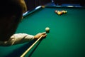 American billiard. Man playing billiard, snooker. Player preparing to shoot, hitting the cue ball. Royalty Free Stock Photo
