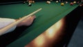 American billiard. Man playing billiard, snooker. Player preparing to shoot, hitting the cue ball.