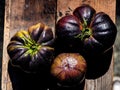 Black heirloom tomatoes on rustic vintage wooden crate Royalty Free Stock Photo
