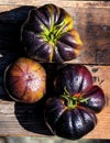 Black heirloom tomatoes on rustic vintage wooden crate Royalty Free Stock Photo