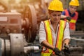 American black women teen worker working part time job as labor in industry factory with heavy steel machine Royalty Free Stock Photo