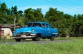 American blue Chevrolet classic car on the country road in Santa Clara - Serie Cuba Reportage Royalty Free Stock Photo