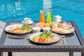 American breakfast near swimming pool, exotic food at luxury hotel resort Royalty Free Stock Photo