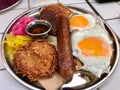 American Breakfast with Pancake Maple Syrup, Sunny Side Up Eggs, Hash Brown, Sausage, Turmeric Pickled Onions and Pickle Royalty Free Stock Photo