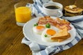 American breakfast with sunny side up eggs, bacon, toast, pancakes, coffee and juice Royalty Free Stock Photo