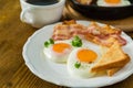 American breakfast with sunny side up eggs, bacon, toast, pancakes, coffee and juice Royalty Free Stock Photo