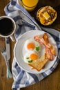 American breakfast with sunny side up eggs, bacon, toast, pancakes, coffee and juice Royalty Free Stock Photo