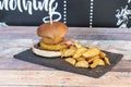 American burger with barbecue sauce, veal covered in cheddar cheese, fried bacon, breaded onion ring Royalty Free Stock Photo