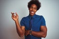 American business man with afro hair wearing blue shirt and tie over isolated white background with a big smile on face, pointing Royalty Free Stock Photo