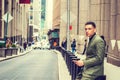 Young American Businessman traveling in New York, texting on street Royalty Free Stock Photo