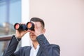 American businessman using binoculars in office. Spy of competitors Royalty Free Stock Photo